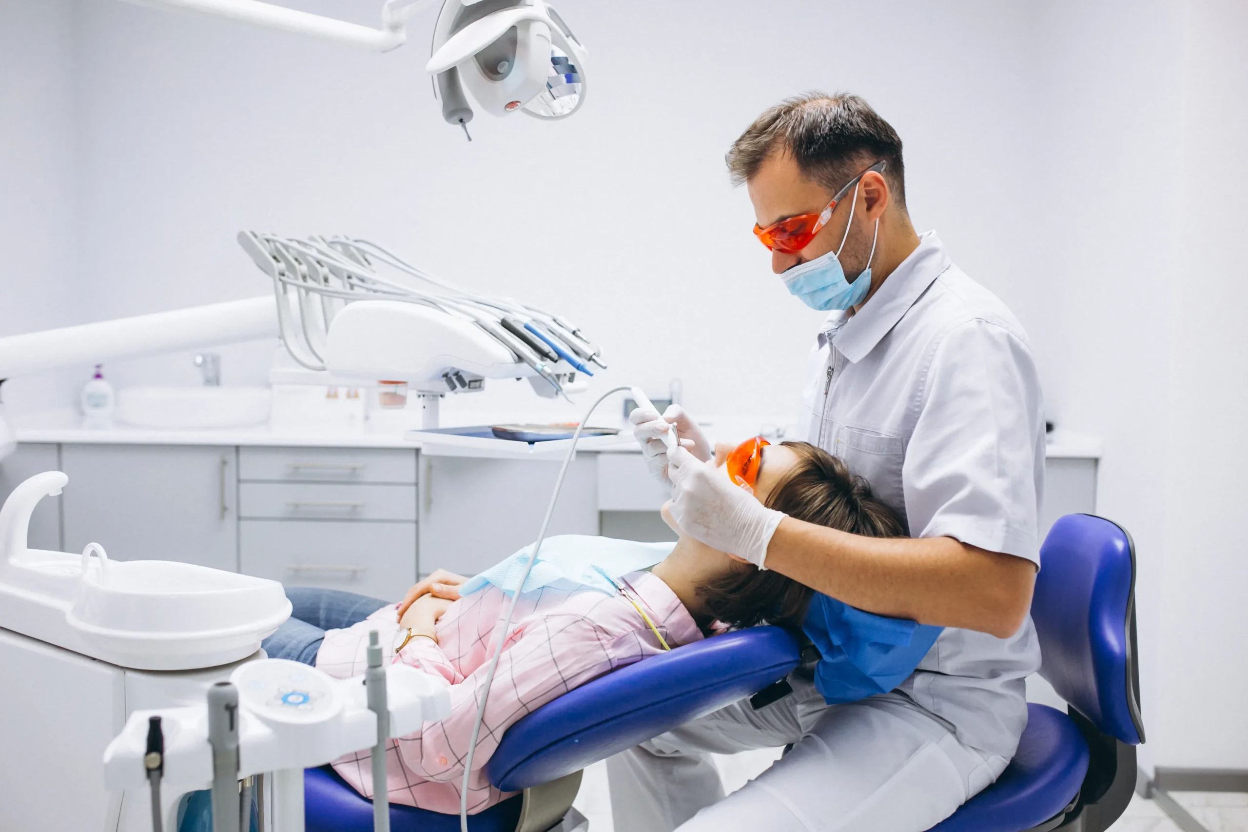 Dentist performing treatment in a modern dental chair at one of the best dental clinics in Kasaragod, providing advanced oral care services.